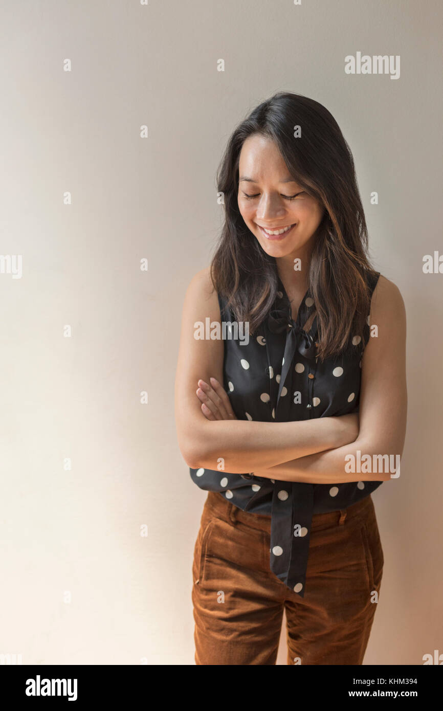 Young woman with crossed arms and closed eyes hi-res stock photography ...