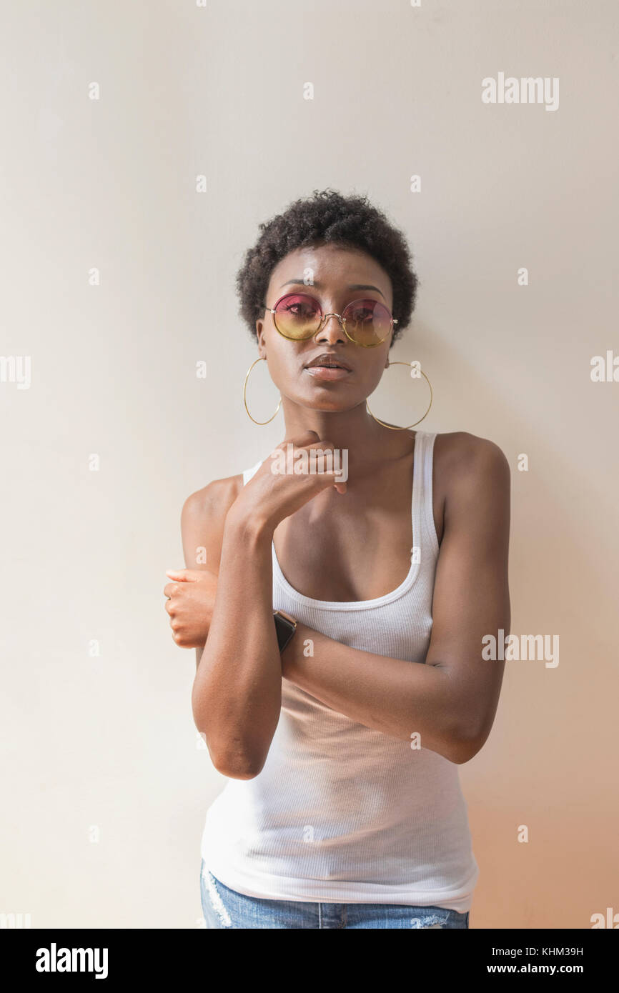 Portrait of a young woman wearing sunglasses Stock Photo - Alamy