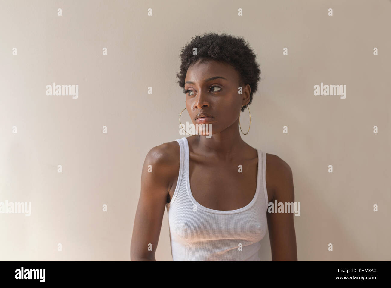 Portrait of a young woman with hoop earrings Stock Photo