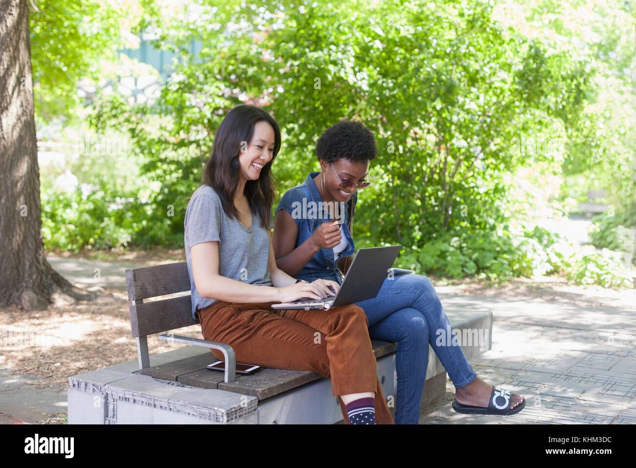 Young women working in a park Stock Photo - Alamy