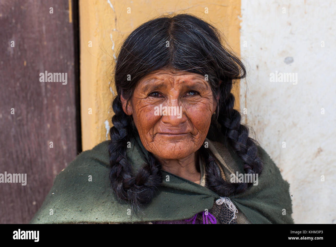 TARATA, COCHABAMBA, BOLIVIA S.A. - OCTOBER 2017: An elderly woman walks along the cobblestone roads of colonial Tarata, Bolivia in October 2017. Stock Photo