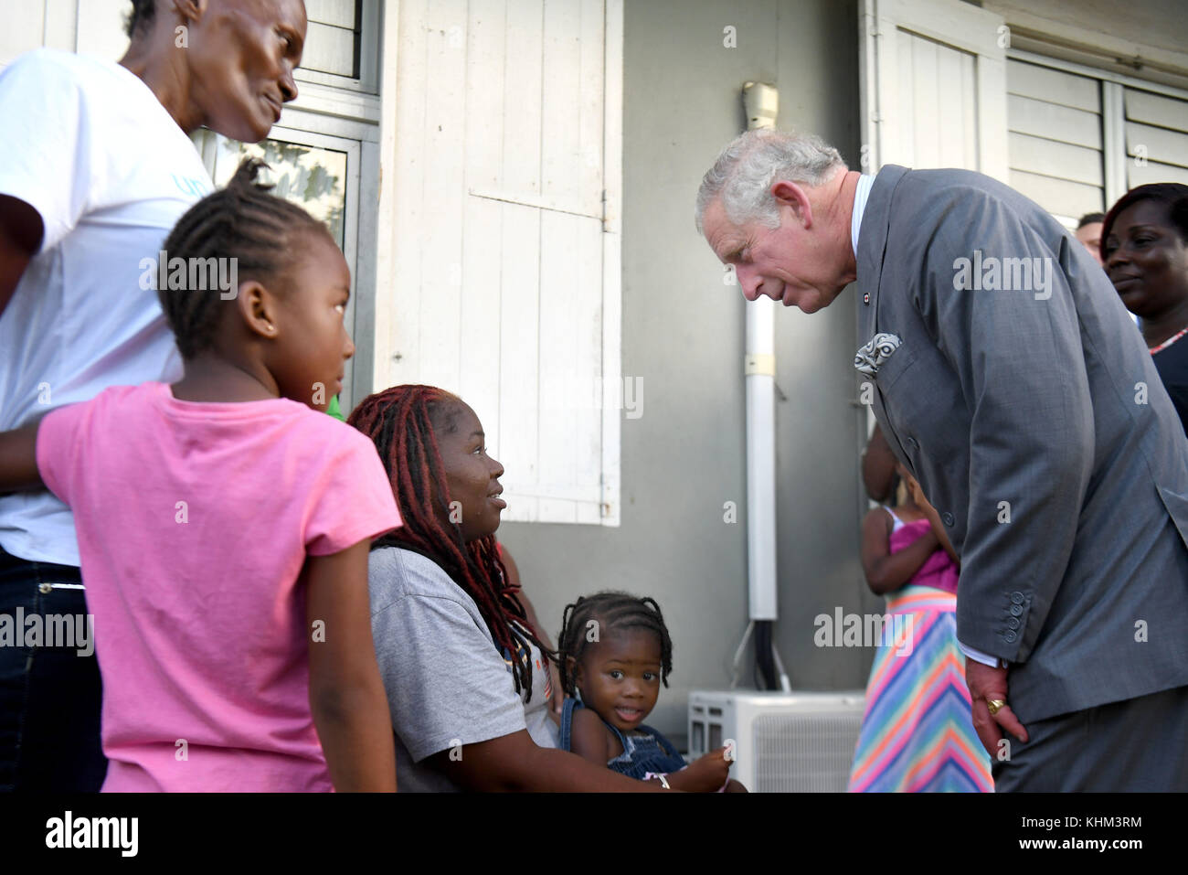 The Prince of Wales speaks to a resident at the temporary shelter at the National Technical Training Centre in Antigua as his tour of hurricane-ravaged Caribbean islands began. Stock Photo