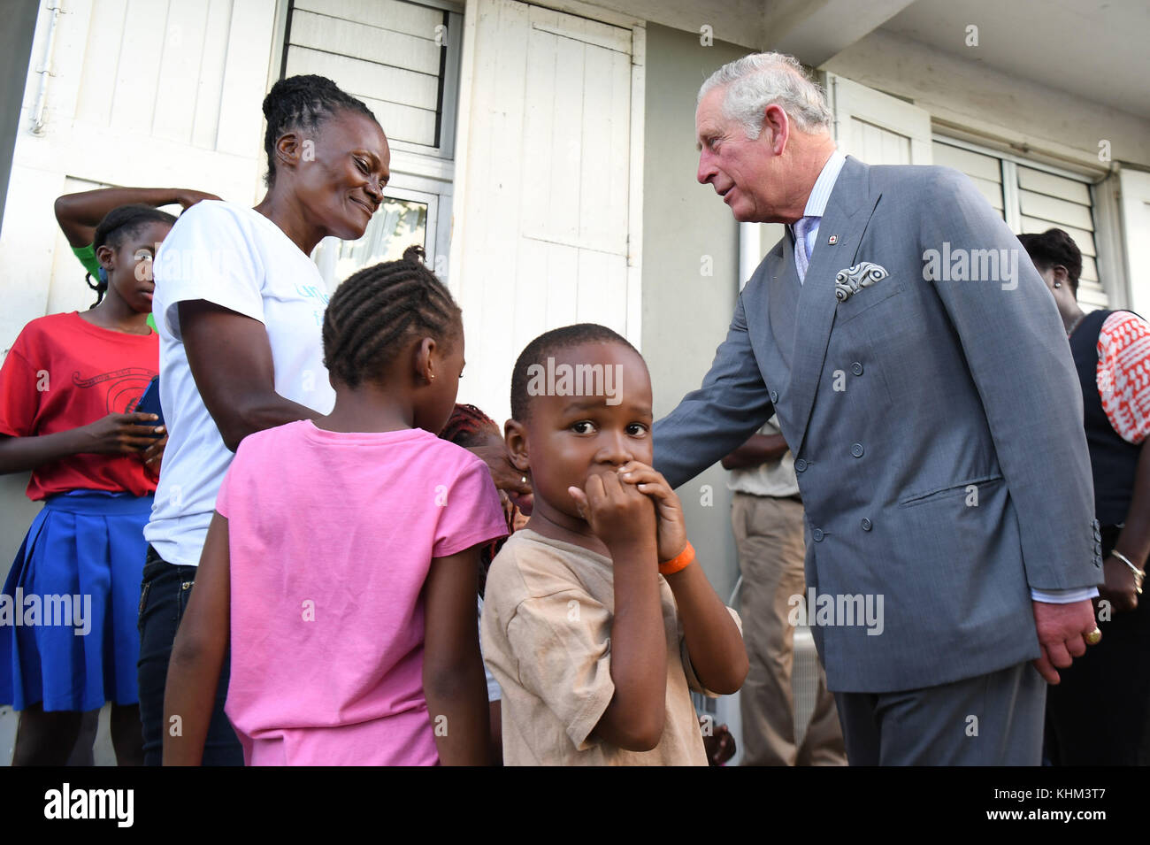 The Prince of Wales speaks to a resident at the temporary shelter at the National Technical Training Centre in Antigua as his tour of hurricane-ravaged Caribbean islands began. Stock Photo