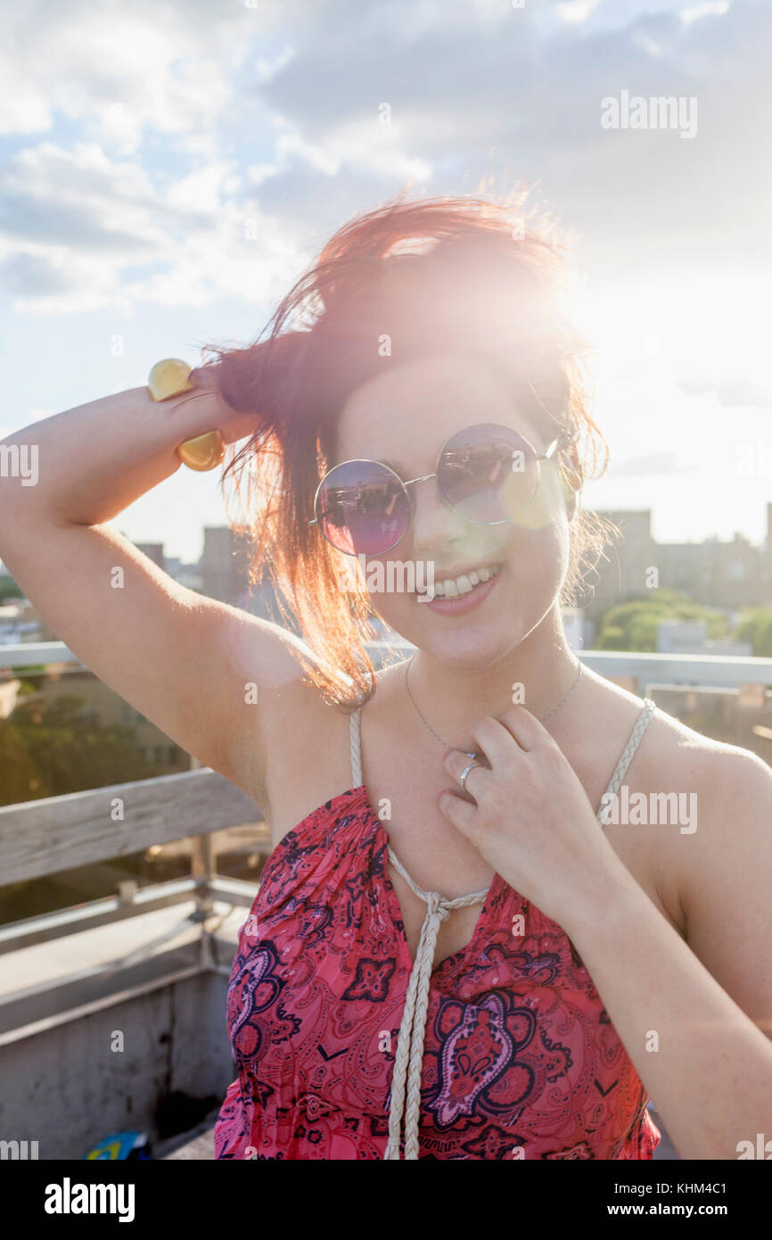 Portrait of a young woman wearing sunglasses at sunset Stock Photo - Alamy
