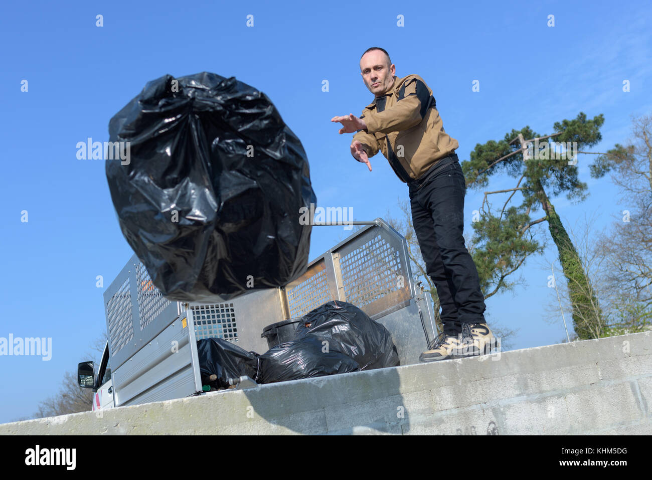 Man throwing refuse bag Stock Photo Alamy