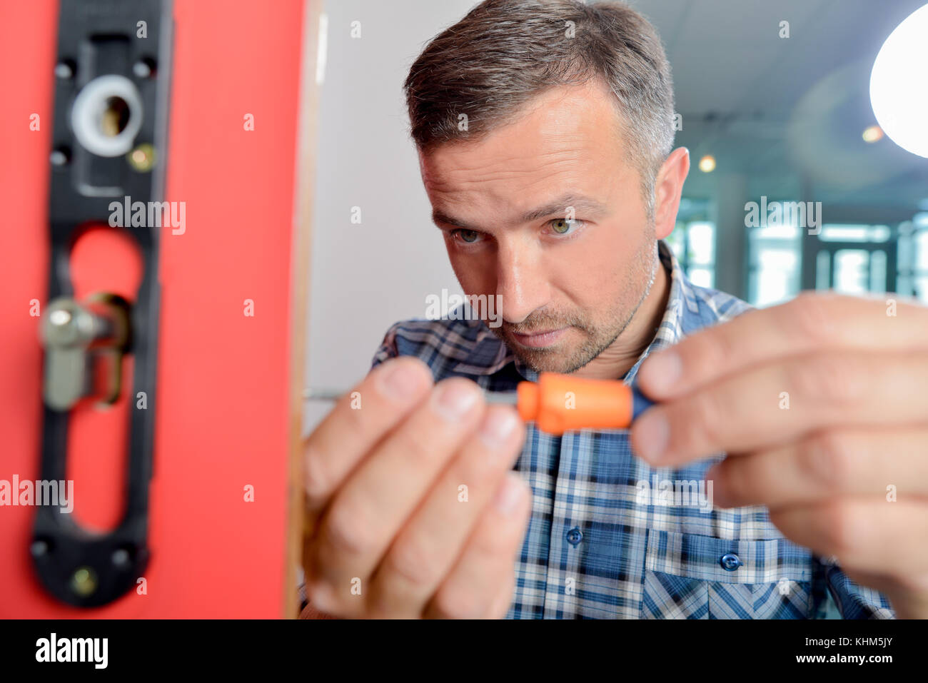Man fitting new door lock Stock Photo Alamy