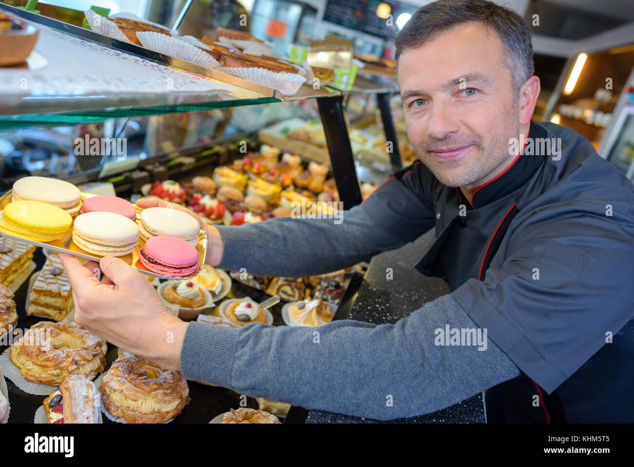 proud pastry chef in his confectionnery Stock Photo Alamy