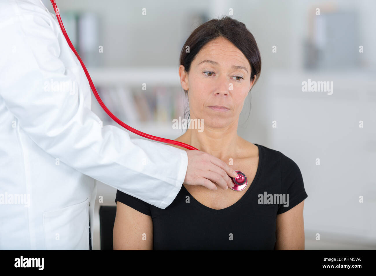 female doctor examining the patient with stethoscope Stock Photo - Alamy