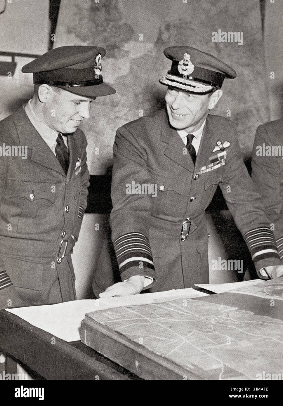 King George VI, right,  meets Guy Gibson, on his return from leading the successful raid by R.A.F. bombers on the great Ruhr dams in May, 1943.  George VI, 1895 – 1952.  King of the United Kingdom and the Dominions of the British Commonwealth.  Wing Commander Guy Penrose Gibson,  1918 – 1944.  First Commanding Officer of the Royal Air Force's No. 617 Squadron, which he led in the 'Dam Busters' raid (Operation Chastise) in 1943. Stock Photo