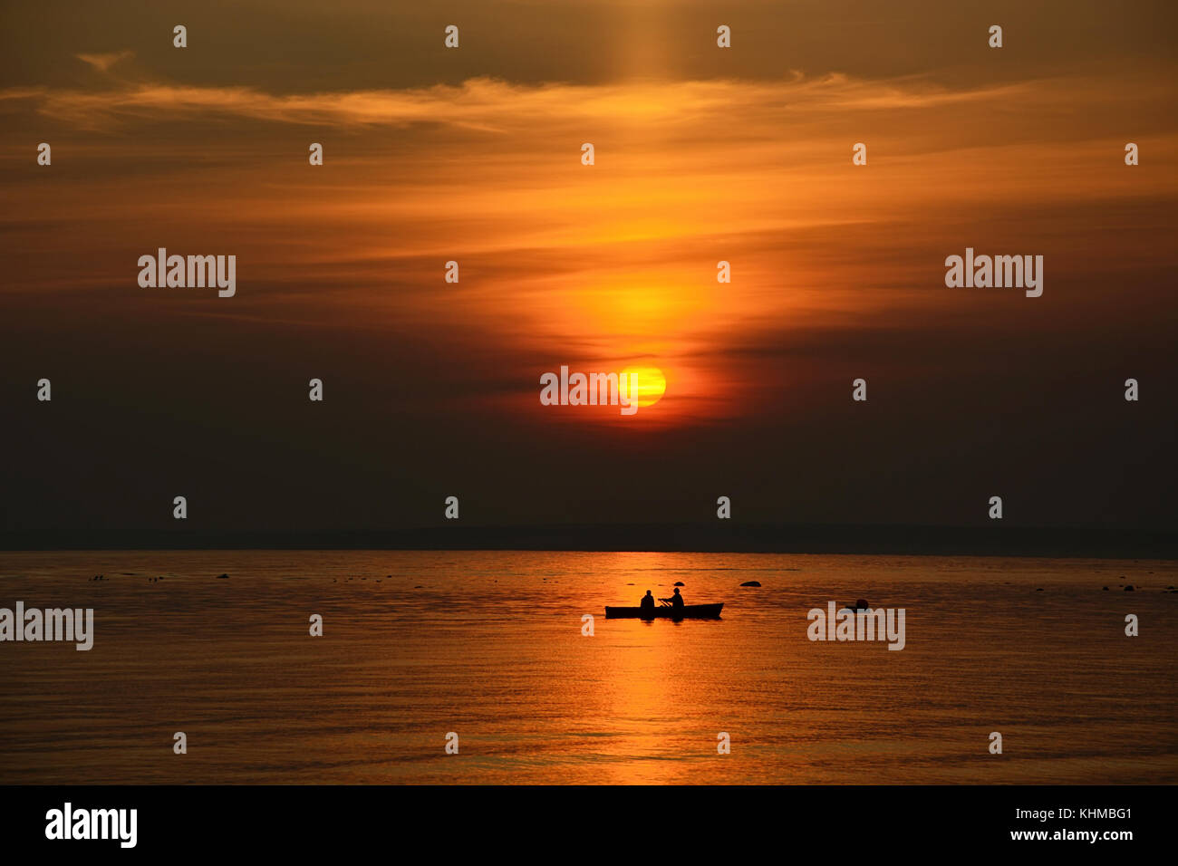 Fisherman boat at the sunset at the ocean Stock Photo - Alamy