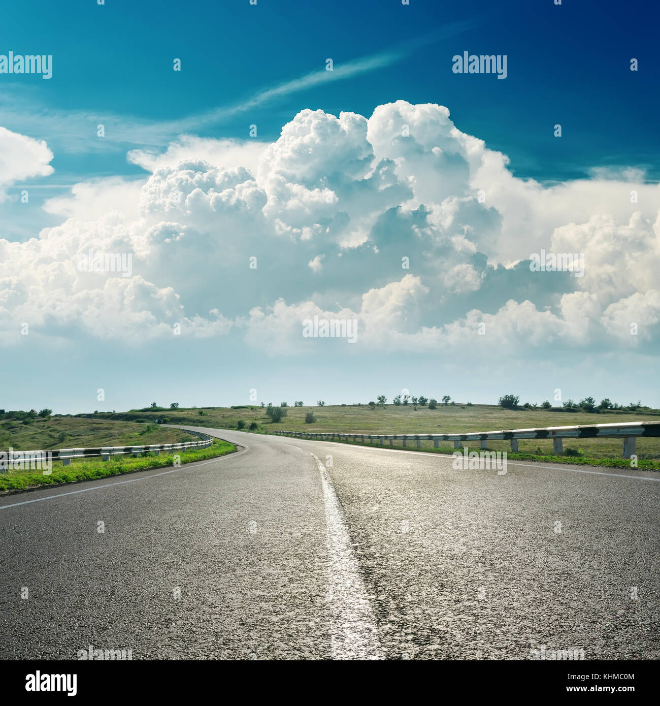 asphalt road to horizon and clouds over it Stock Photo - Alamy