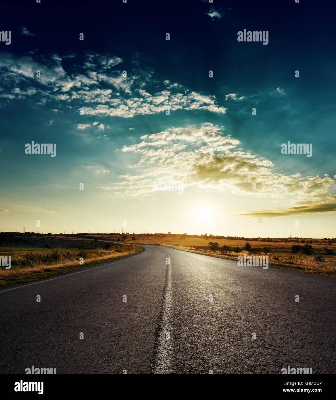 sunset over asphalt road with white line Stock Photo - Alamy