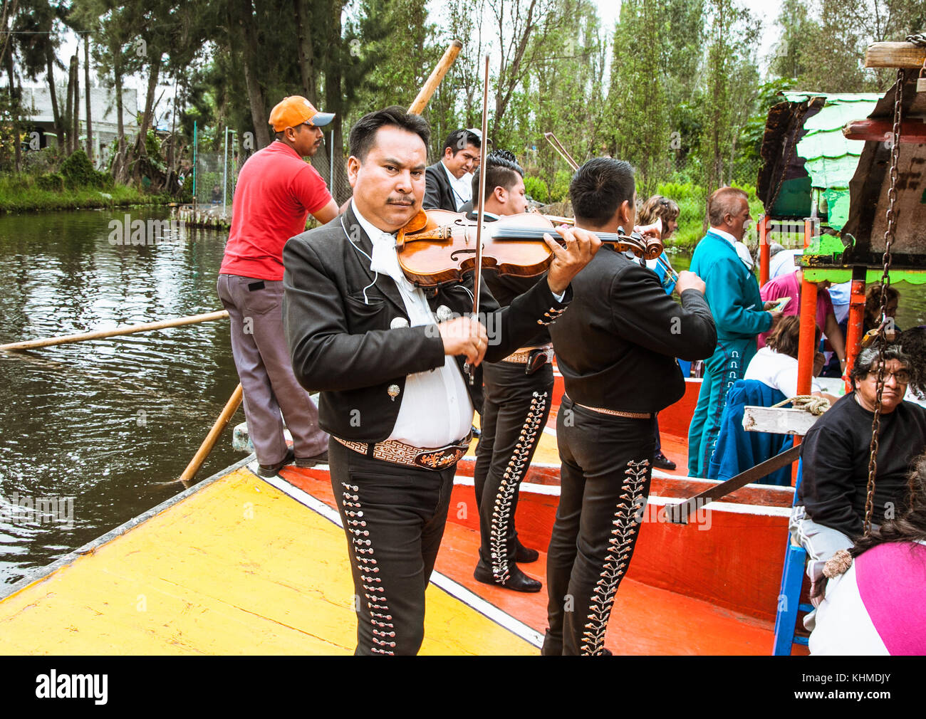 XOCHIMILCO,MEXICO- DEC 3. 2015: Mariachi guitar players and dancers performs on drifting barges on  Dec 3. 2015  in Mexico city. System of canals in M Stock Photo