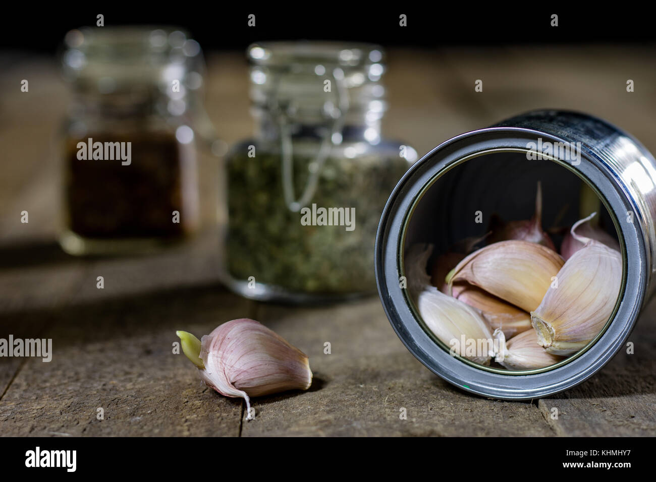 Garlic in woods and spices on a wooden table. Garlic cloves on the ...