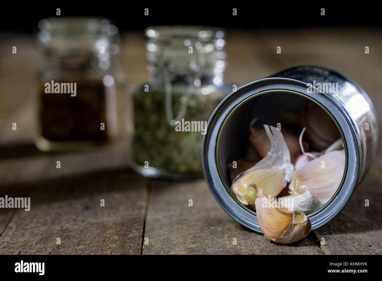 Garlic in woods and spices on a wooden table. Garlic cloves on the ...