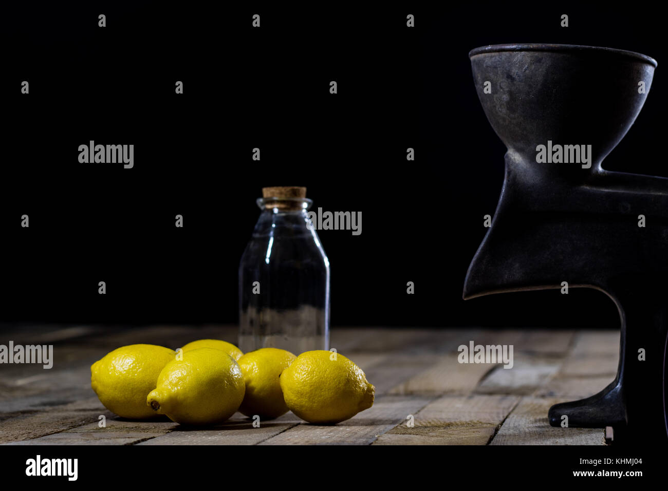 old cast iron juice machine on a wooden kitchen table. Lemon juice and