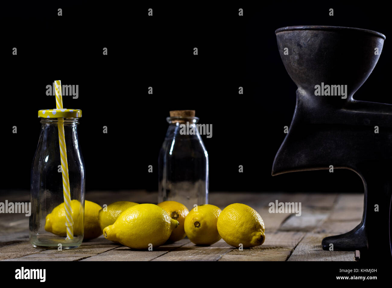 old cast iron juice machine on a wooden kitchen table. Lemon juice and