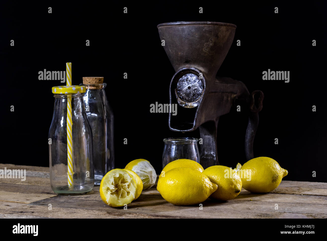 old cast iron juice machine on a wooden kitchen table. Lemon juice and
