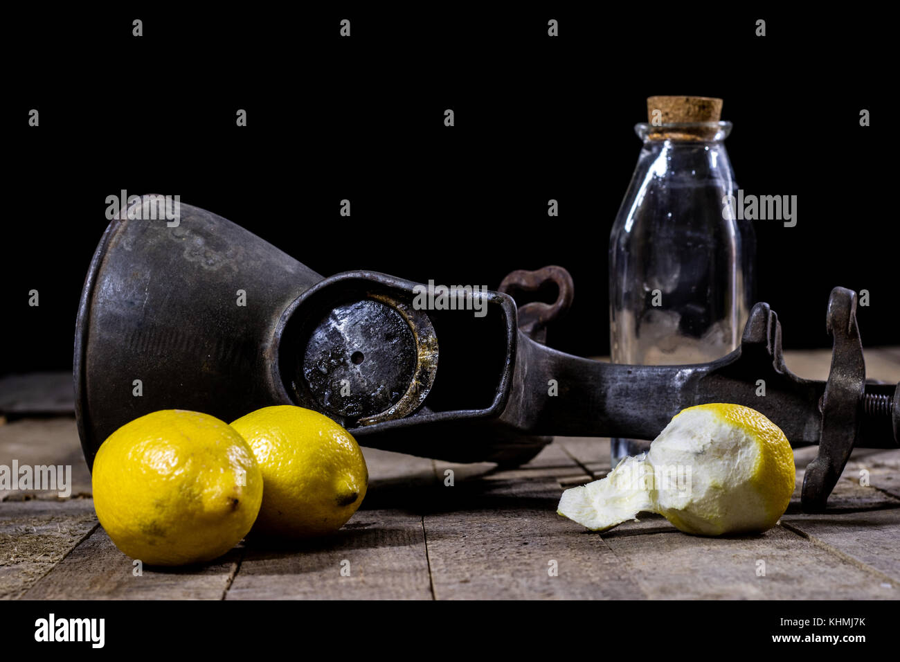 old cast iron juice machine on a wooden kitchen table. Lemon juice and