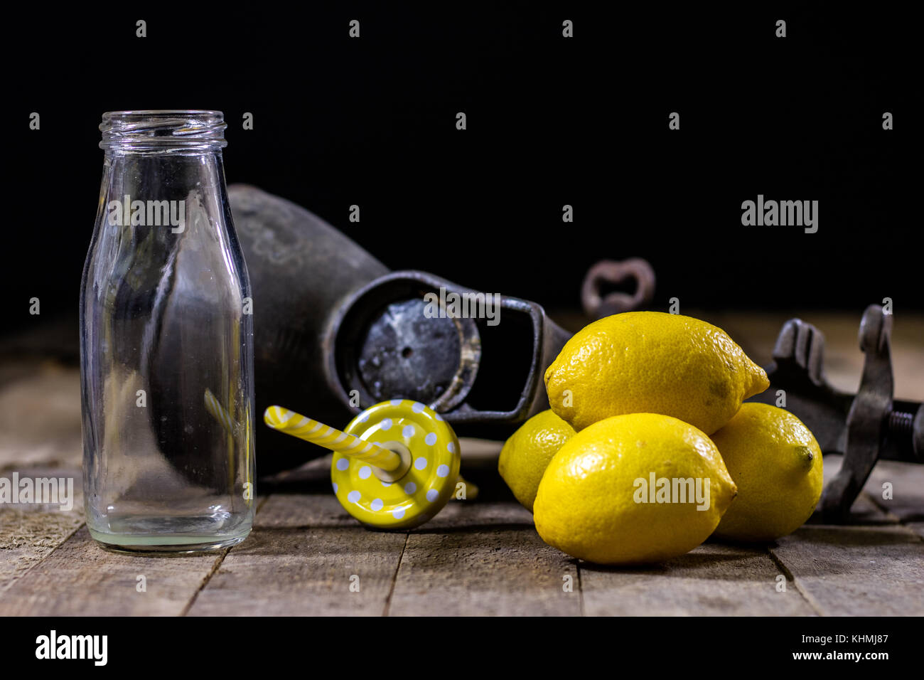 old cast iron juice machine on a wooden kitchen table. Lemon juice and