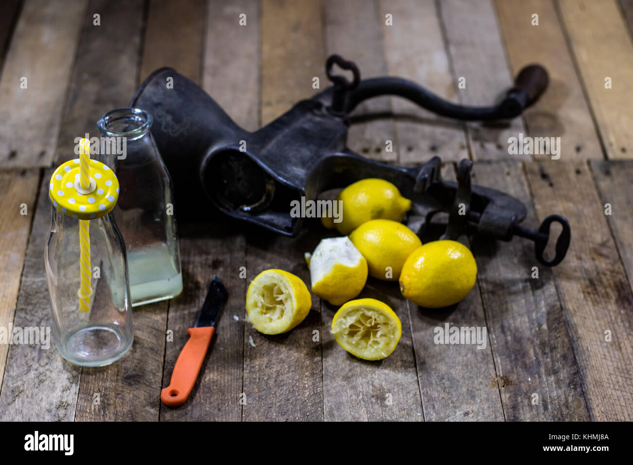 old cast iron juice machine on a wooden kitchen table. Lemon juice and