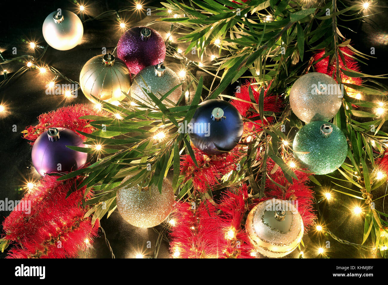 Christmas Baubles and Bottlebrush on Black Background Stock Photo