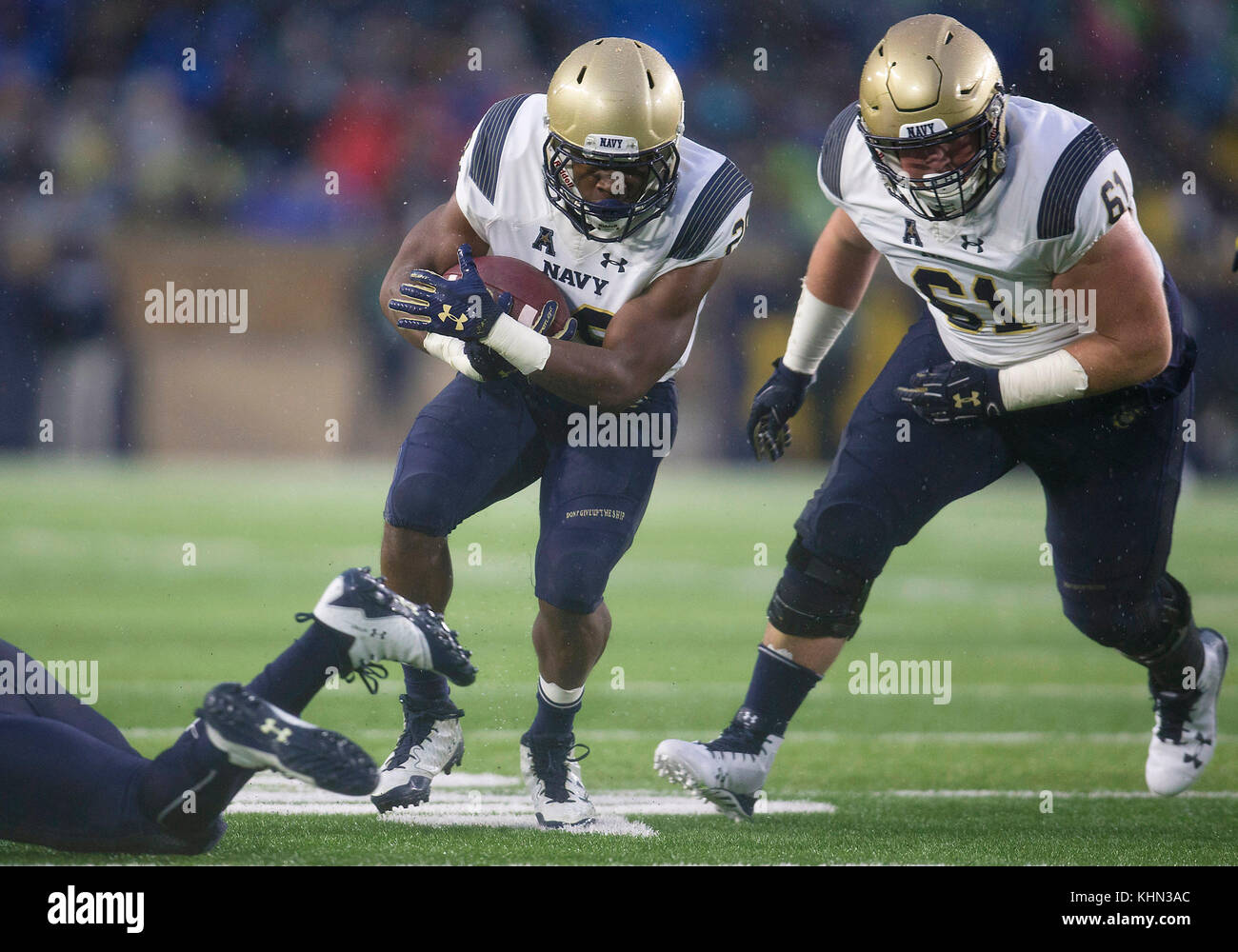 South Bend, Indiana, USA. 18th Nov, 2017. Navy running back Josh Brown (28) runs with the ball as Navy offensive lineman Andrew Wood (61) leads the way during NCAA football game action between the Navy Midshipmen and the Notre Dame Fighting Irish at Notre Dame Stadium in South Bend, Indiana. Notre Dame defeated Navy 24-17. John Mersits/CSM/Alamy Live News Stock Photo