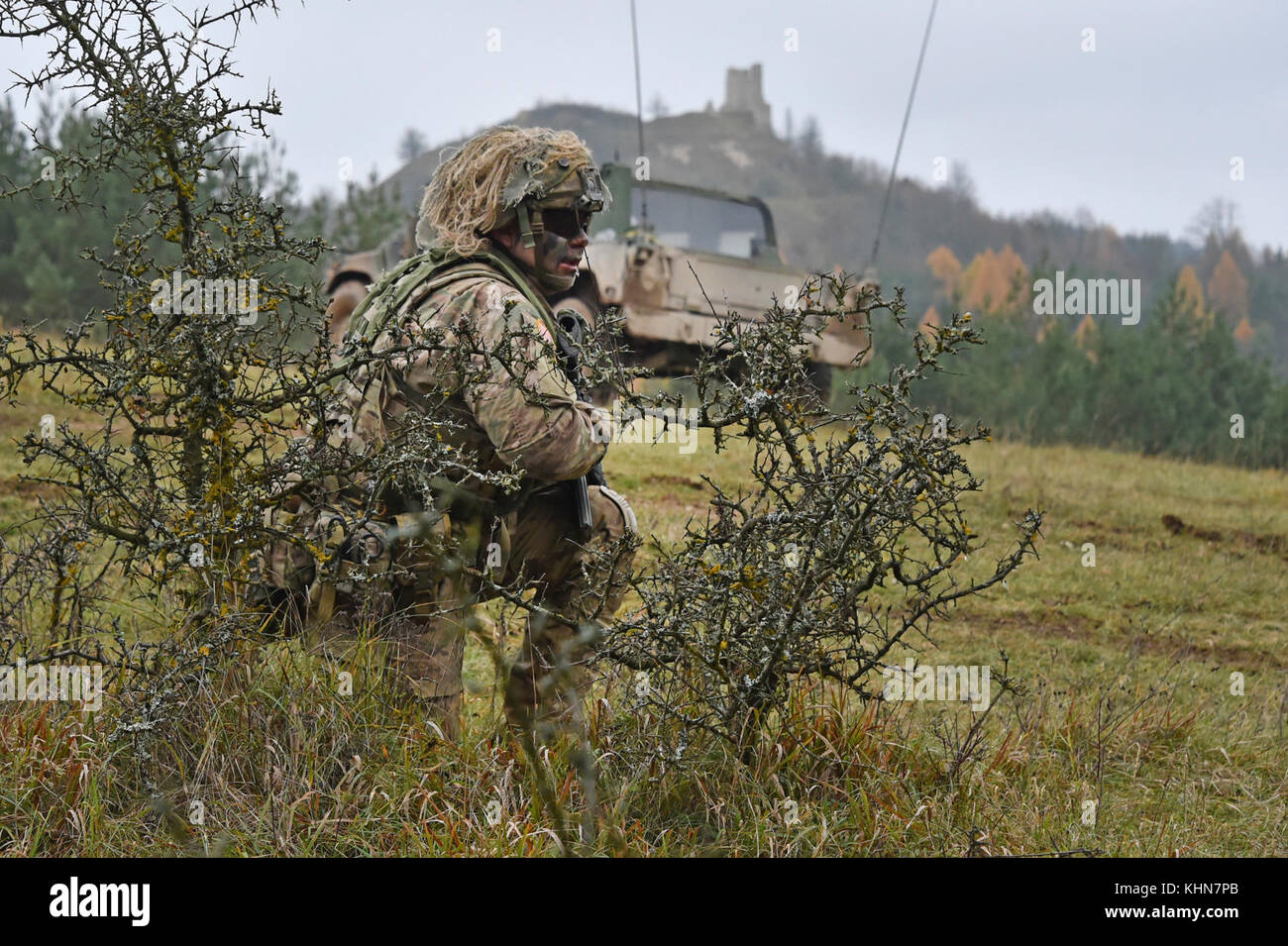 U.S. Army Staff Sgt. Marcin Szewczyk with 1st Squadron, 2nd Cavalry Regiment overlooks the terrain during Exercise Allied Spirit VII at the 7th Army Training Command’s Hohenfels Training Area, Germany, Nov. 16, 2017. Approximately 4,050 service members from 13 nations are participating in the exercise from Oct. 30 to Nov. 22, 2017. Allied Spirit is a U.S. Army Europe-directed, 7ATC-conducted multinational exercise series designed to develop and enhance NATO and key partner’s interoperability and readiness. (U.S. Army photo by Gertrud Zach) Stock Photo