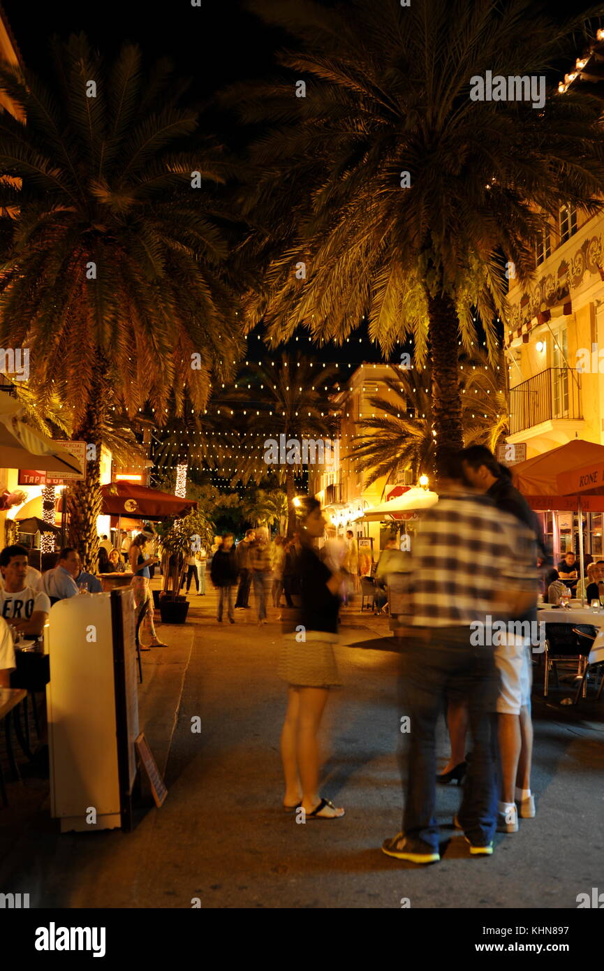 Bustling crowds of people in the restaurant and shopping street of Espanola Way, historic Spanish village of South Beach, Miami, Florida, USA. Stock Photo