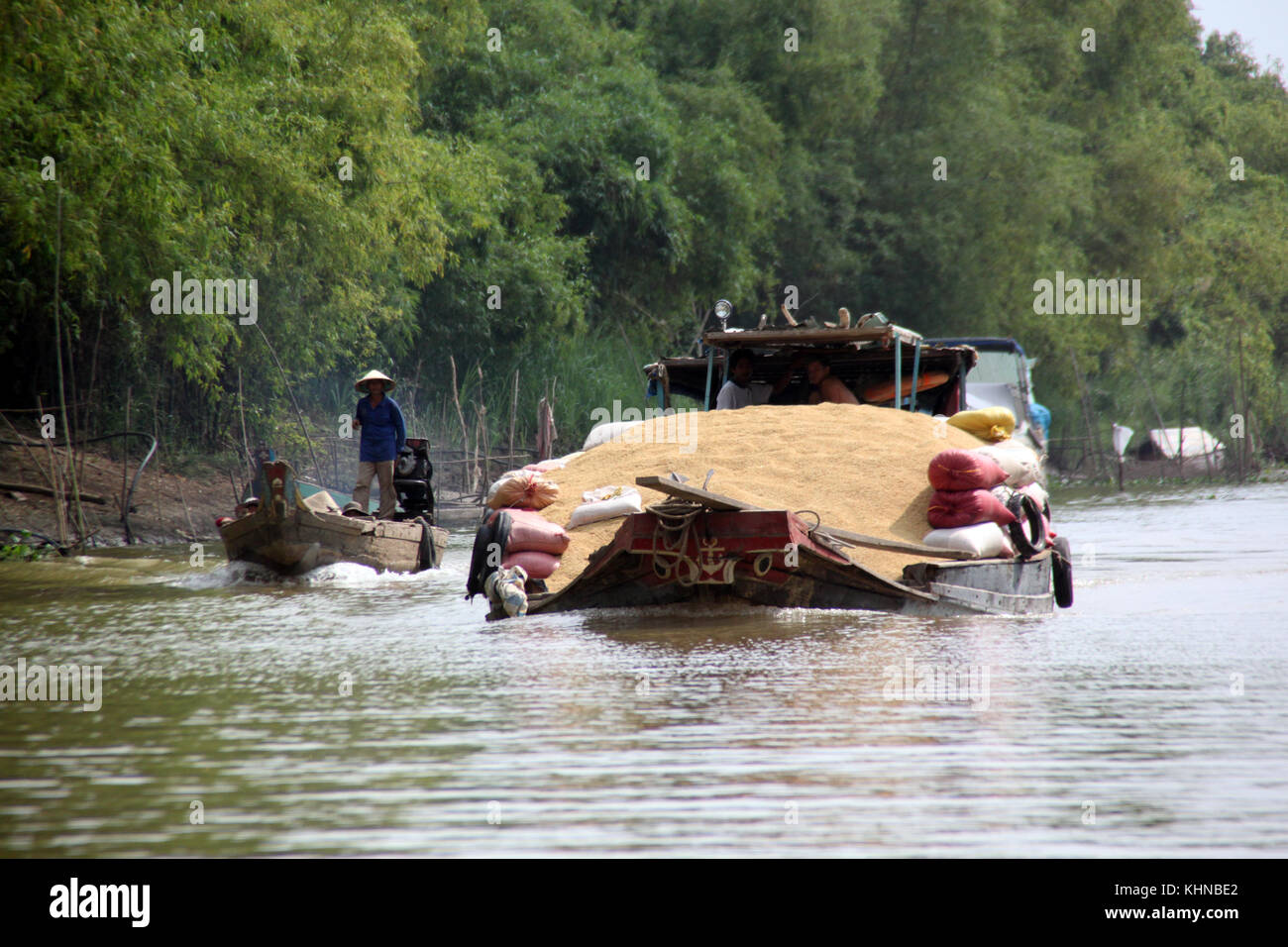 Boat with full load of grain on Mekong river in Vietnam Stock Photo