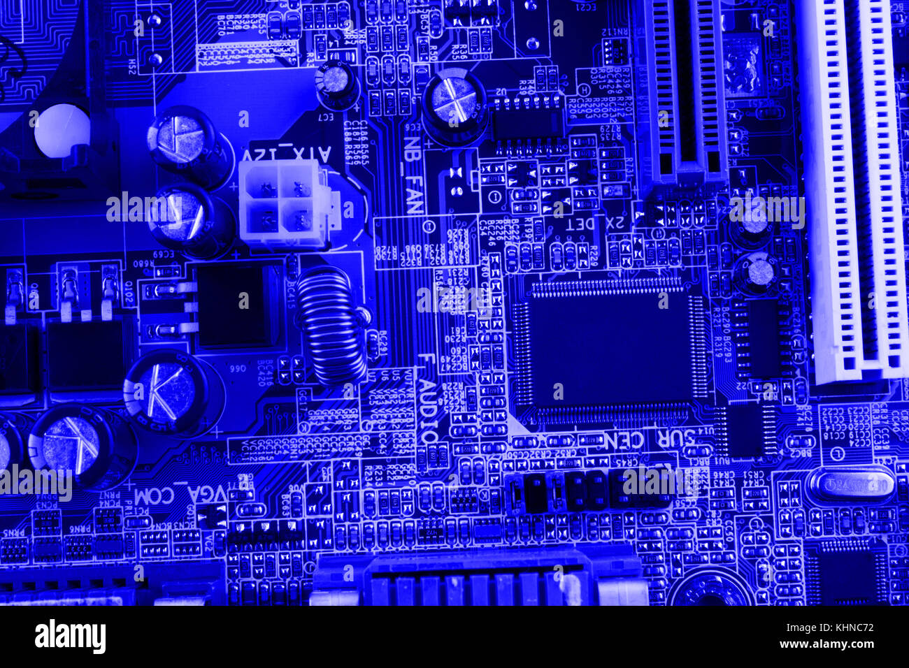 Integrated semiconductor microchip on blue circuit board representative of the high tech industry and computer science. Stock Photo