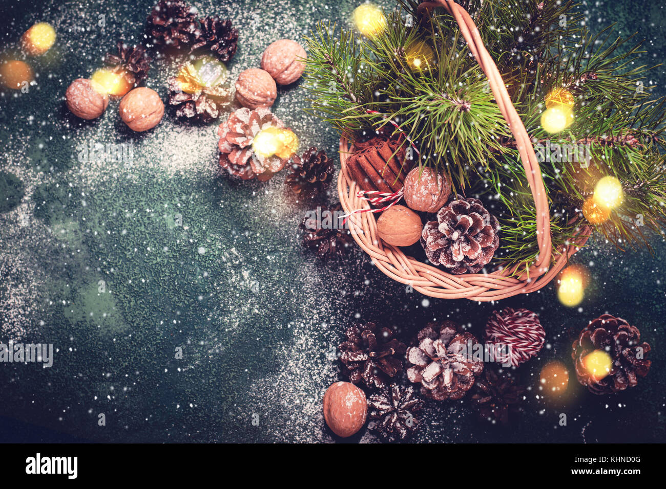 Christmas card. Basket with fir cones and branches, nuts and cinnamon ...