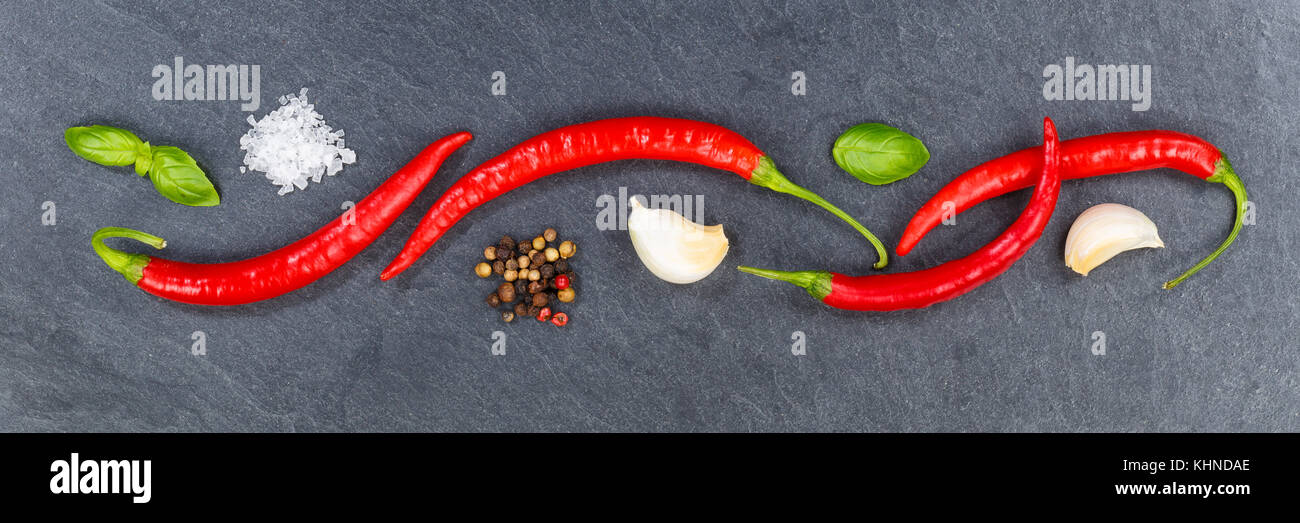 Red hot chili peppers chilli cooking ingredients banner slate background top view above Stock Photo