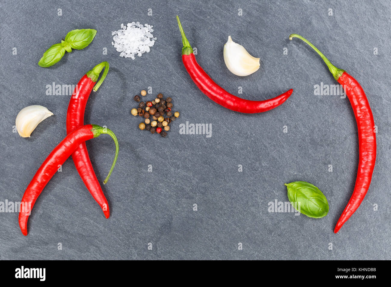 Red hot chili peppers chilli cooking ingredients slate background top view above Stock Photo