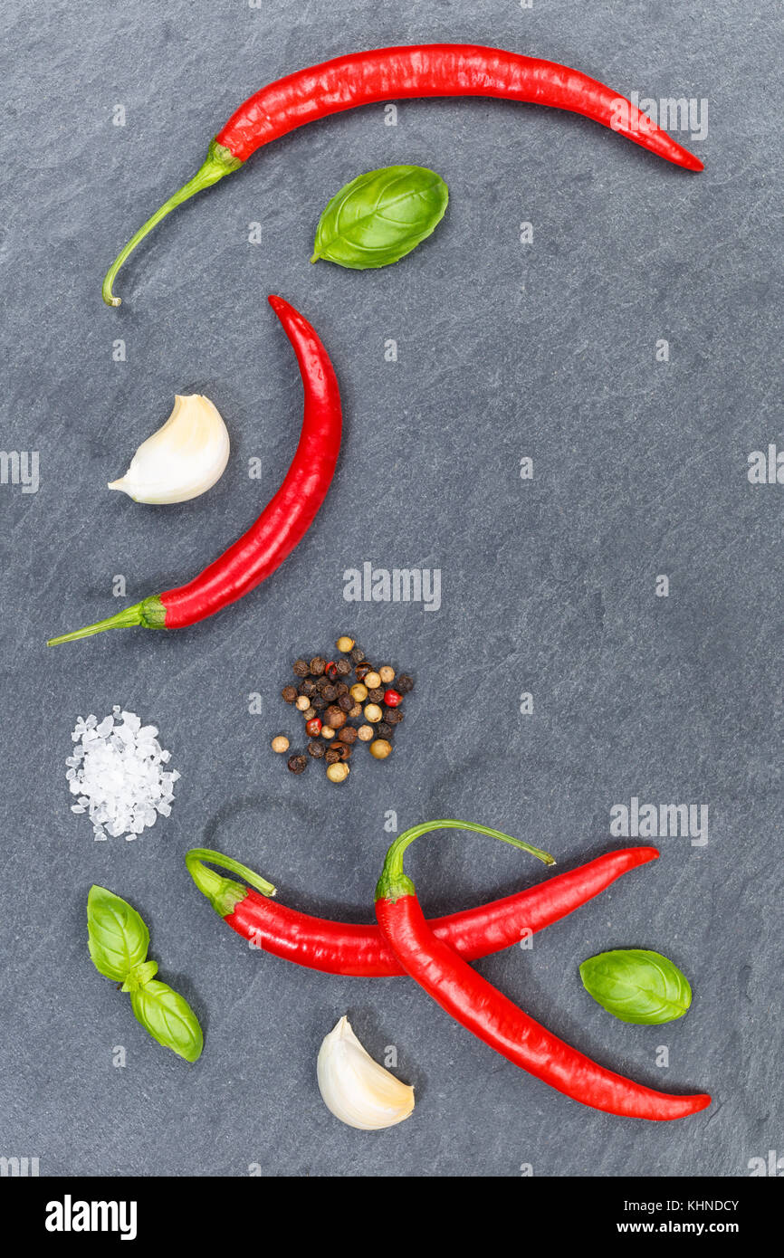 Red hot chili peppers chilli cooking ingredients portrait format slate background top view from above Stock Photo