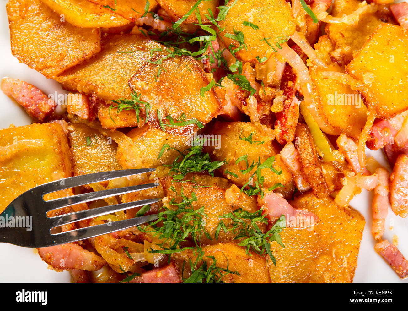 Potatoes and bacon cooked in the oven Stock Photo