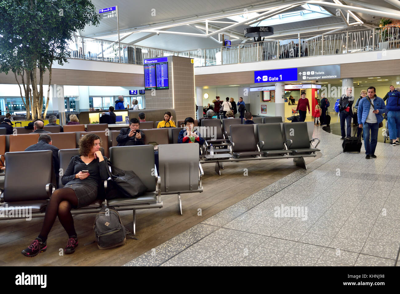 Relaxing while waiting in airport departure lounge at Bristol Airport, UK Stock Photo