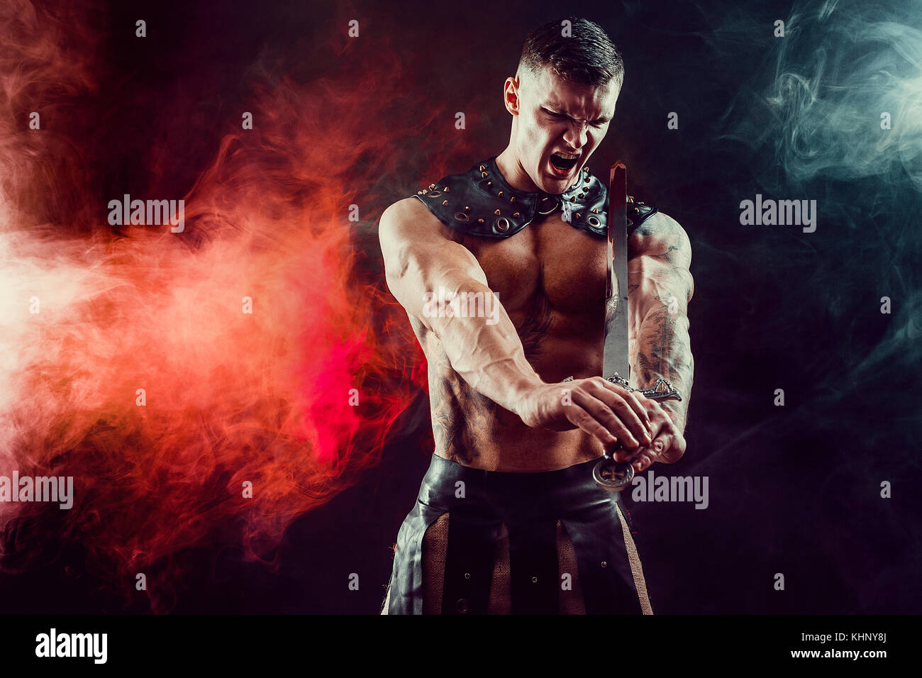 Severe barbarian in leather costume with sword Stock Photo