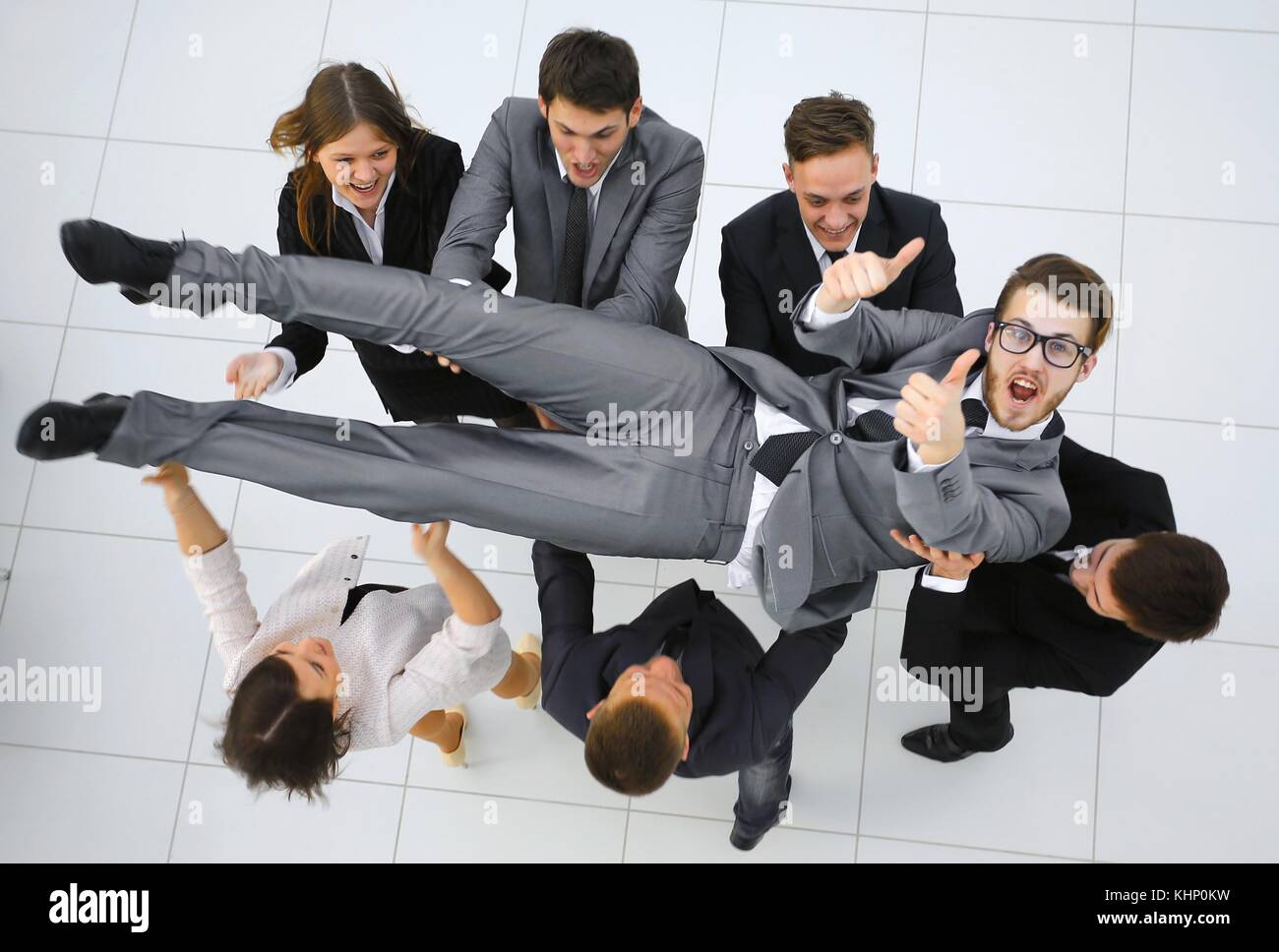 triumphant business team shakes their leader Stock Photo - Alamy