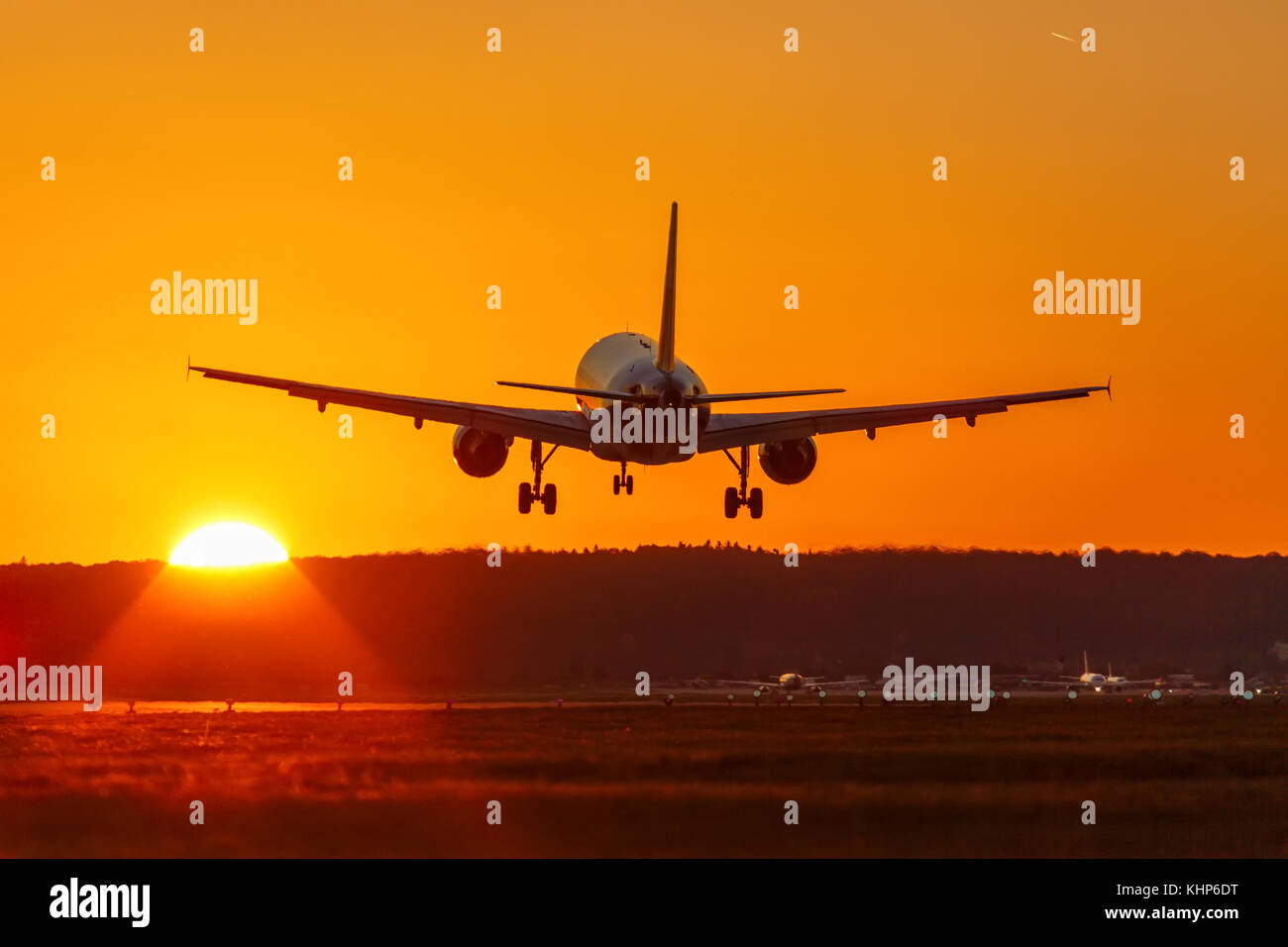 Airplane landing flying airport sun sunset vacation holidays travel traveling plane aircraft travelling Stock Photo