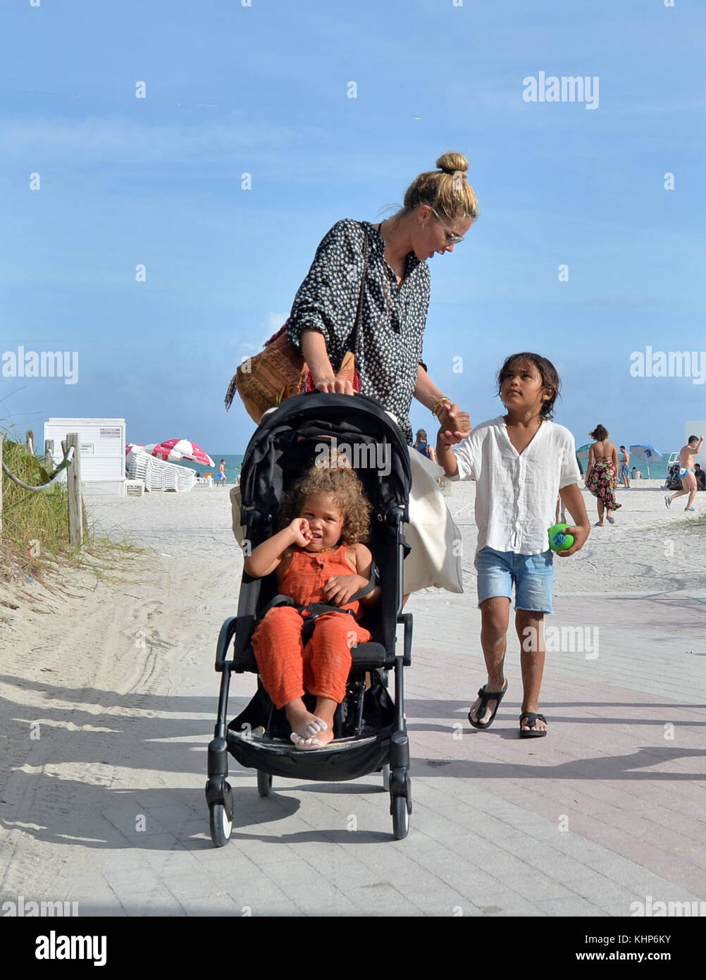 MIAMI, FL - JANUARY 03: Doutzen Kroes the former Victoria's Secret Angel  wearing a skimpy black triangle string bikini was joined by her adorable  children, son Phyllon, five, and daughter Myllena, two