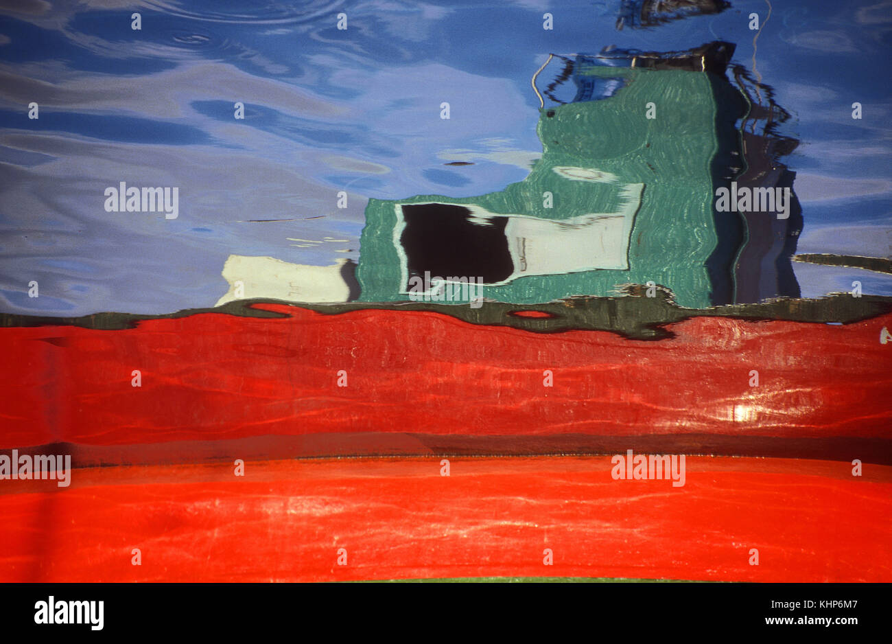 Colourful boat reflected in water Stock Photo - Alamy