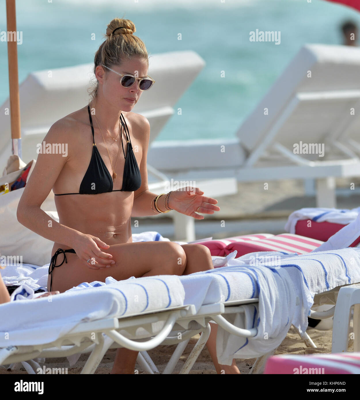 MIAMI, FL - JANUARY 03: Victoria's Secret supermodel Doutzen Kroes looks like she's on her last nerve when her kids looked like they were having temper tantrums at the beach. Doutzen was wearing a skimpy black triangle string bikini as she tried to hold it together and cheer up, her son Phyllon, five, and daughter Myllena. A few minuets later the family left the beach perhaps for a much needed nap for everyone on January 3, 2017 in Miami  Florida  People:  Doutzen Kroes Stock Photo