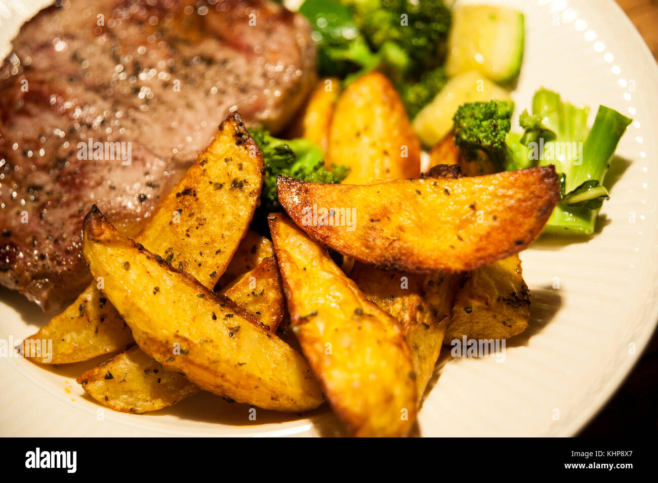 Beefsteak with Baked Potatoes,Broccoli and Zucchini Stock Photo