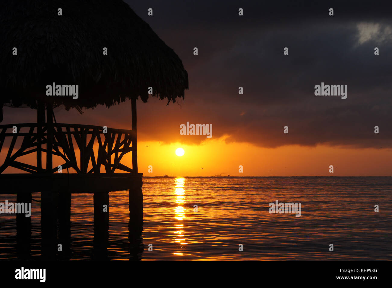Sunset, cloud and hut on the sea shore in Carribean coast of Guatemala Stock Photo