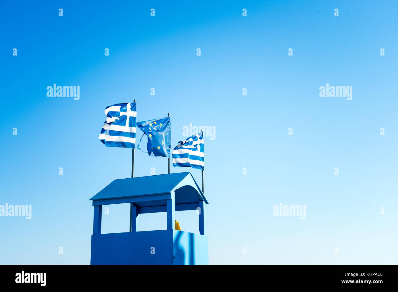 Greek Flag And EU Flag, Blue Sky And Viewpoint Hut In Blue Color In Palaria Katerini, Greece Stock Photo