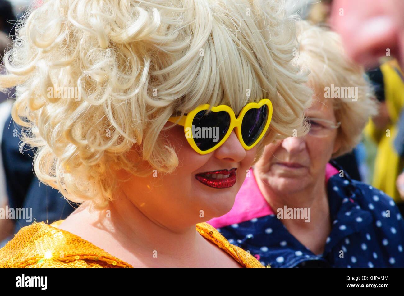 Female performer wearing a costume, love heart sunglasses and a wig on