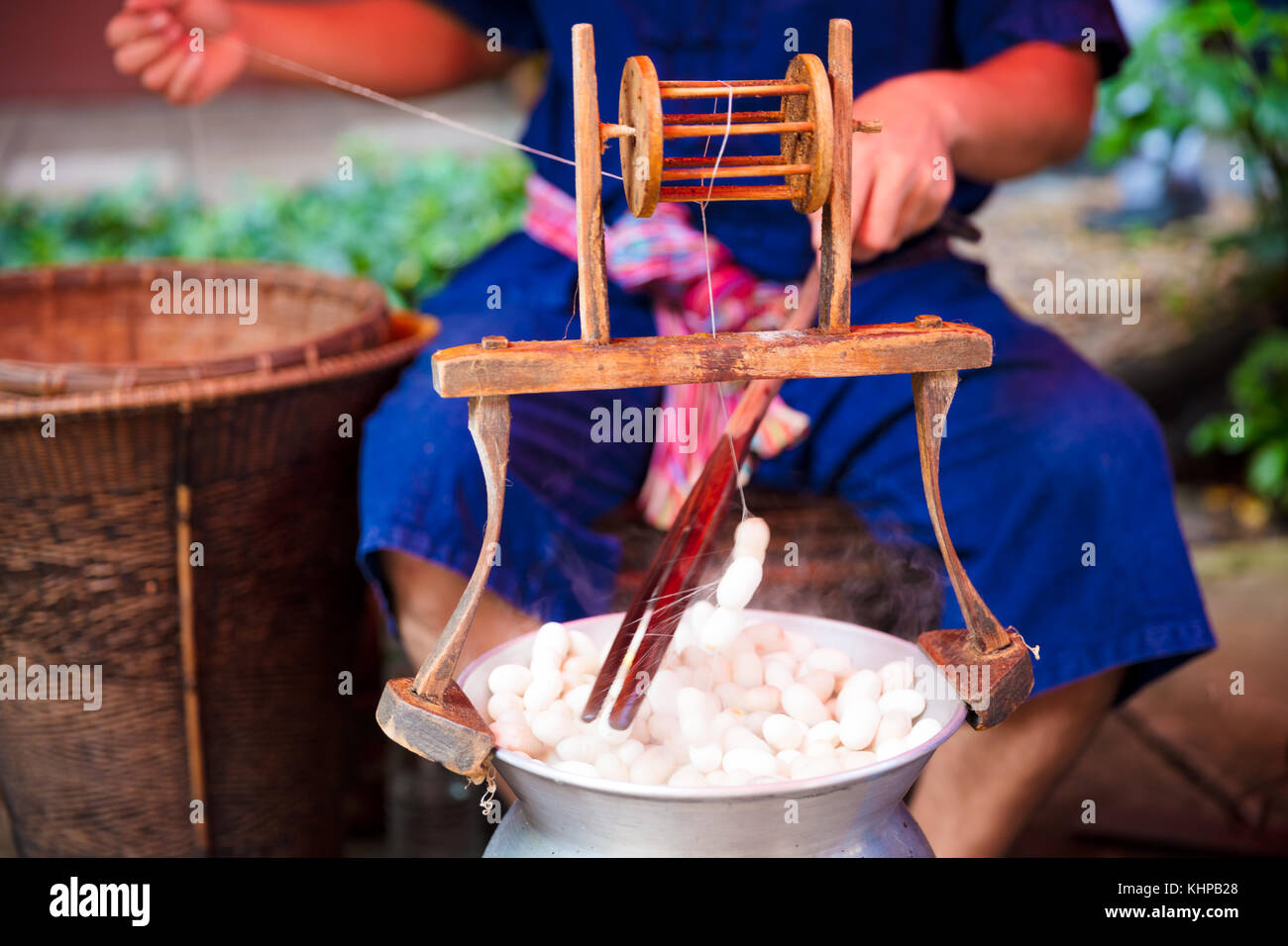 Man Unwinding And Reeling Silk Cocoons In Factory Stock Photo