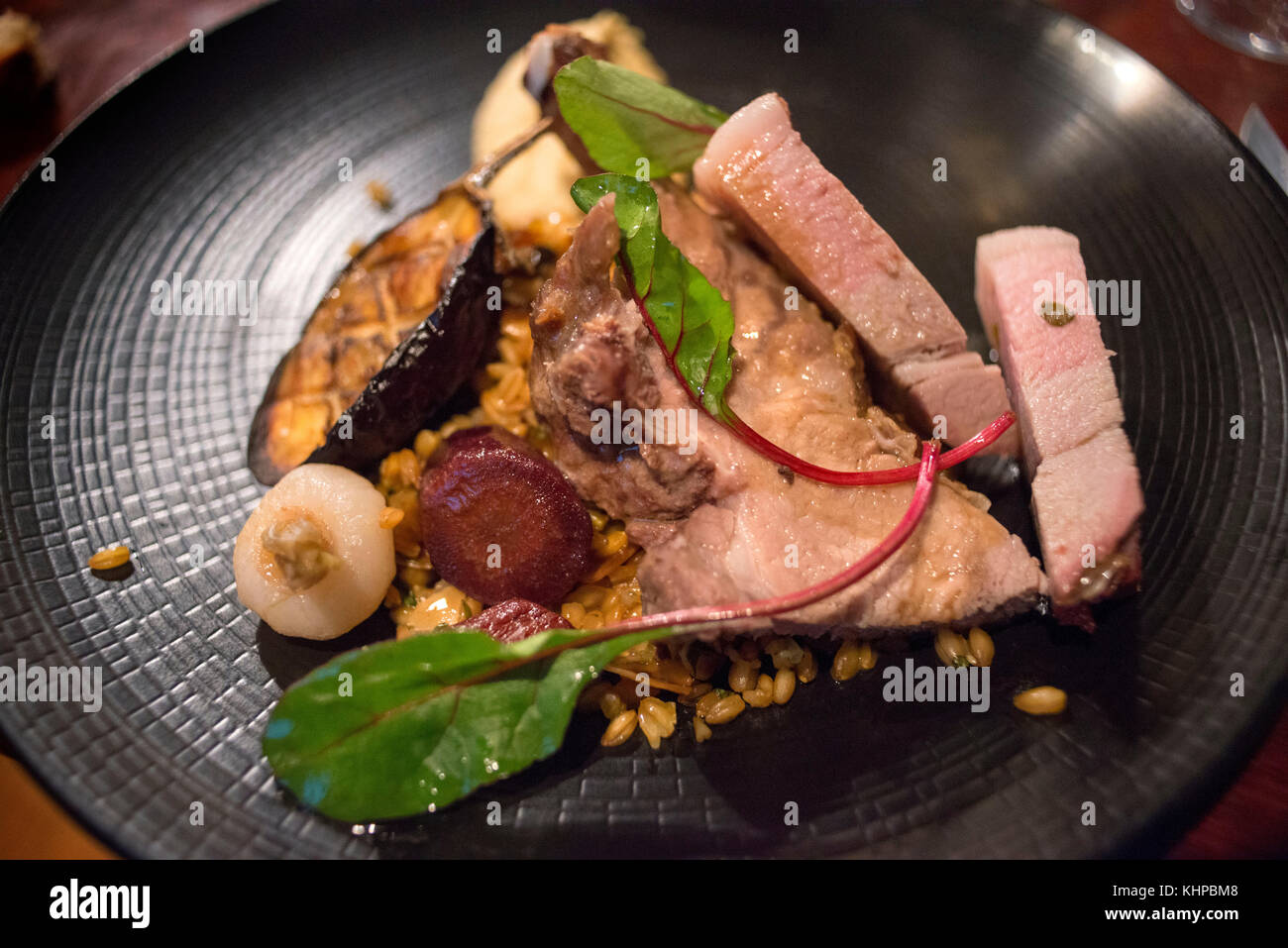 Gourmet organic pork dish in Pickles restaurant in old city town of Nantes, Loire Atlantique, France. Stock Photo