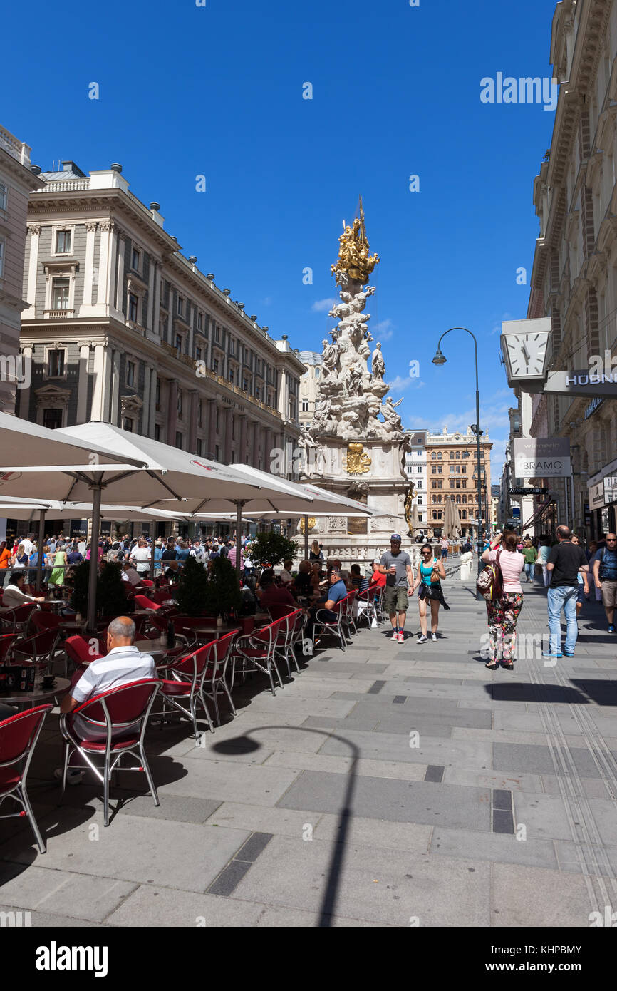 Graben street in city of Vienna, Austria, outdoor cafe restaurant and Holy Trinity Plague Column Stock Photo